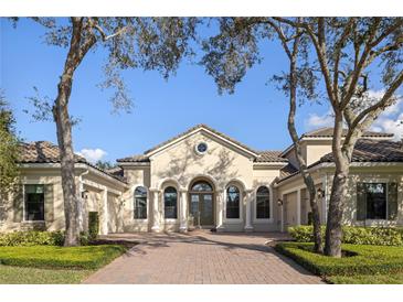 Elegant one-story home with brick driveway and manicured landscaping at 8681 Crested Eagle Pl, Sanford, FL 32771