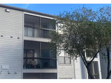 Two-story building with balconies and screened-in patios at 2030 Cascades Blvd # 302, Kissimmee, FL 34741