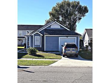 Gray house with a two-car garage and a landscaped lawn at 2314 Carriage Run Rd, Kissimmee, FL 34741