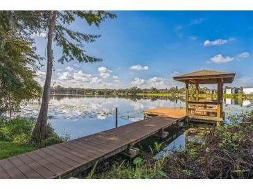 Wooden gazebo on a pier overlooking a lake at 4834 Hall Rd, Orlando, FL 32817