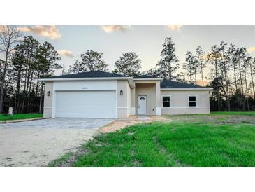 New construction home with attached garage and landscaped yard at 2642 Magnolia Cir, Lake Wales, FL 33898