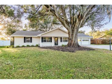House with mature oak tree in front yard at 5105 Forestgreen W Dr, Lakeland, FL 33811