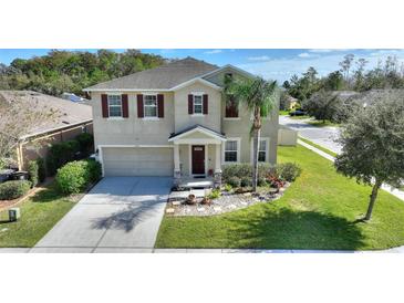 Two-story house with a landscaped yard at 2056 Marabou Dr, Davenport, FL 33896