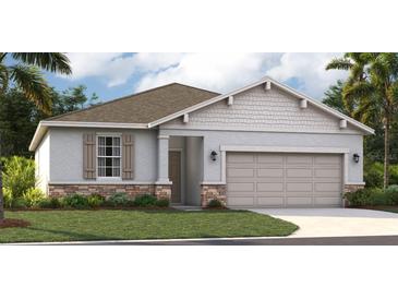 One-story house with gray siding and two-car garage at 811 Pebble Crest Ln, Eagle Lake, FL 33839