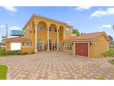 Two-story Mediterranean home with tile roof and attached garage at 7440 Aloma Ave, Winter Park, FL 32792