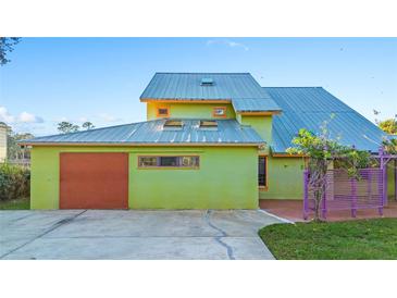 Unique home with metal roof, large garage, and colorful accents at 360 Rest Haven Rd, Geneva, FL 32732