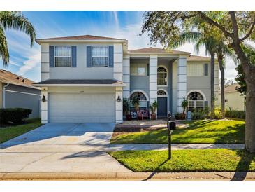 Two-story house with gray siding, gray shutters, and a two-car garage at 1349 Castleport Rd, Winter Garden, FL 34787