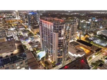 Nighttime aerial view of a modern highrise building with city lights at 155 S Court Ave # 2609, Orlando, FL 32801