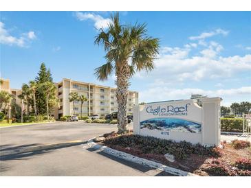 Castle Reef Condominium building, featuring a sign and parking lot at 4175 S Atlantic Ave # 1240, New Smyrna Beach, FL 32169