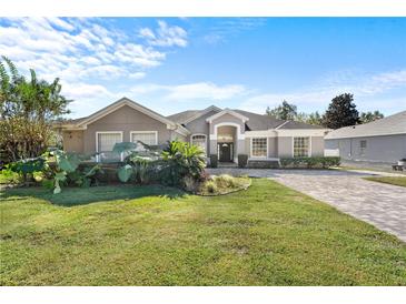 Single-story home with a landscaped lawn and paved driveway at 6807 Sylvan Woods Dr, Sanford, FL 32771