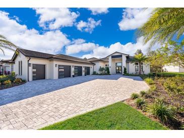 Luxury home with three-car garage and paver driveway at 15144 Pendio Dr, Montverde, FL 34756