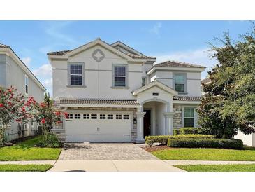 Two-story home with stone accents and a three-car garage at 1680 Moon Valley Dr, Davenport, FL 33896