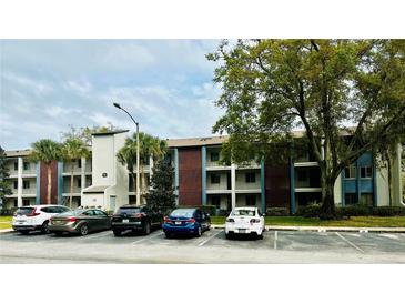 Exterior view of a condo building with parking and landscaping at 3 Escondido Cir # 18, Altamonte Springs, FL 32701
