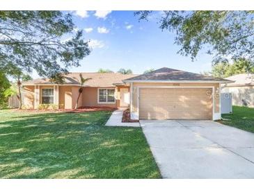 One-story house with attached garage and well-maintained lawn at 13303 Pinyon Dr, Clermont, FL 34711