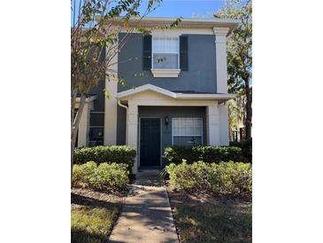 Inviting two-story townhome with a charming front porch and well-manicured landscaping at 3660 Wilshire Way Rd # 260, Orlando, FL 32829