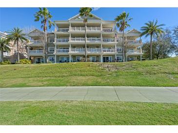 Multi-story condo building with balconies and lush landscaping at 1370 Centre Court Ridge Dr # 304, Kissimmee, FL 34747