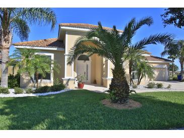 Beautiful one-story home with palm trees and well-manicured lawn at 3555 Maribella Dr, New Smyrna Beach, FL 32168