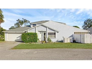 Two-story house with attached garage and well-maintained landscaping at 1067 Cheltanham Ct, Longwood, FL 32750