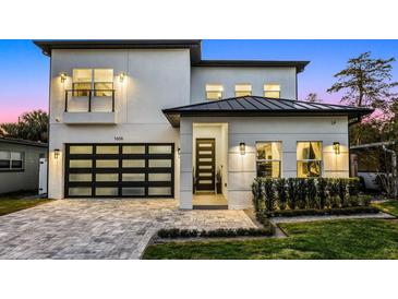 Stunning two-story home with a modern design, featuring a metal roof and landscaped front yard at 1606 Hart Ln, Orlando, FL 32804