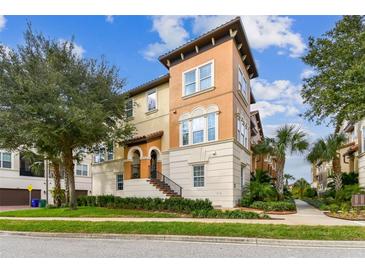 3-story townhome with Spanish-style architecture, landscaped grounds, and a 2-car garage at 1801 Lobelia Dr, Lake Mary, FL 32746