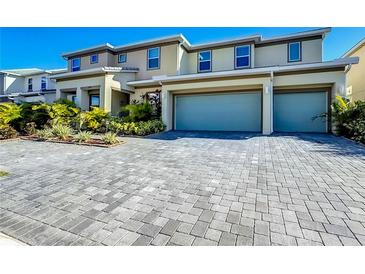Two-story house with two-car garage and landscaped front yard at 2477 Shanti Dr, Kissimmee, FL 34746