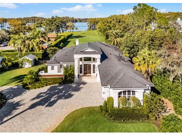 Luxury waterfront home with expansive grounds, pool, and tennis court at 2810 Lake Howell Ln, Winter Park, FL 32792