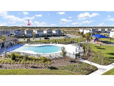 Community pool with lounge chairs and playground nearby at 4704 Homestead Trl, St Cloud, FL 34772