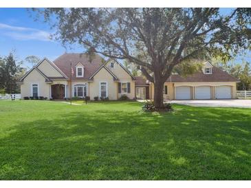 House exterior shows a large two-story home with a three-car garage and large lawn at 8500 Winter Garden Vineland Rd, Orlando, FL 32836