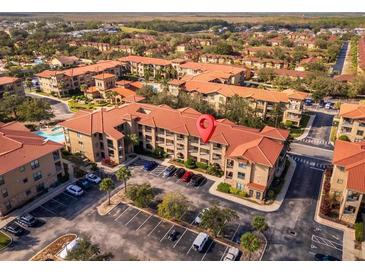 Aerial view showing the condo building's location and surrounding area at 903 Charo Pkwy # 836, Davenport, FL 33897