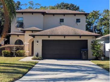 Two-story house with a two-car garage and landscaped lawn at 1720 Crocker Ave, Orlando, FL 32806