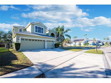 Two-story house with three car garage and landscaped yard at 2338 Darlin Cir, Orlando, FL 32820