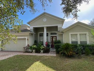 Attractive two-story house with a manicured lawn and a large front porch at 912 Hire Cir, Ocoee, FL 34761