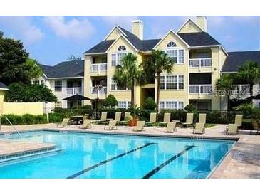 Community pool with apartment building in background at 1023 S Hiawassee Rd # 4022, Orlando, FL 32835