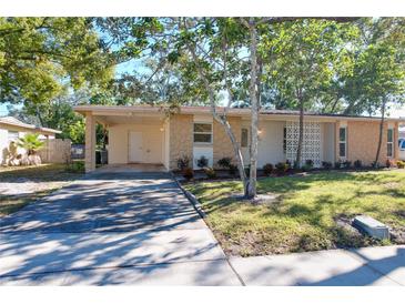 Ranch style home with carport and landscaped yard at 705 Beverly Ave, Altamonte Springs, FL 32701