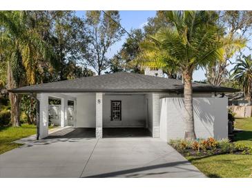 Updated home exterior with carport and landscaping at 8 Pine Ct, Yalaha, FL 34797