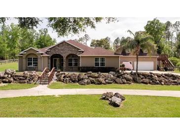 One-story home with stone accents and a large backyard at 12128 Sw 41St Pl, Ocala, FL 34481