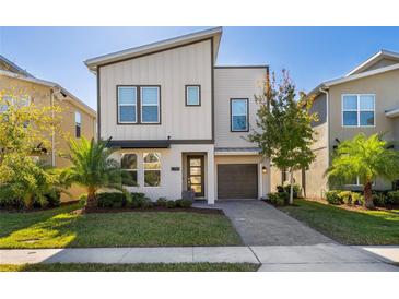 Modern two-story home with attached garage and landscaped lawn at 2759 Bookmark Dr, Kissimmee, FL 34746