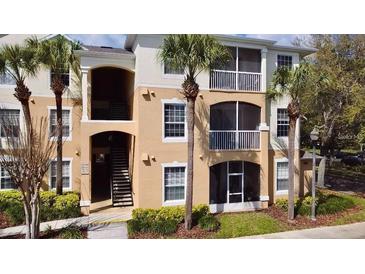 Two-story condo building with palm trees and balconies at 3190 Dante Dr # 304, Orlando, FL 32835