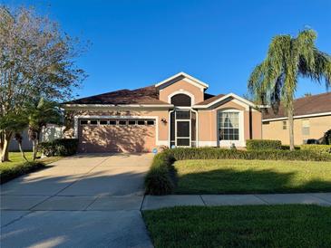 Attractive single-story home with a two-car garage and landscaped yard at 3218 Stonehurst Cir, Kissimmee, FL 34741