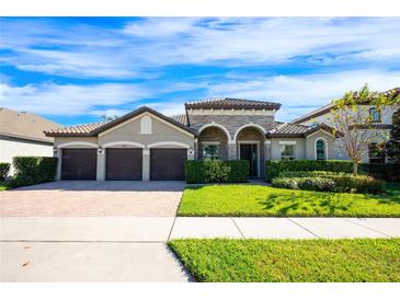 House exterior featuring three-car garage, manicured lawn, and attractive landscaping at 3400 Stonewyck St, Orlando, FL 32824