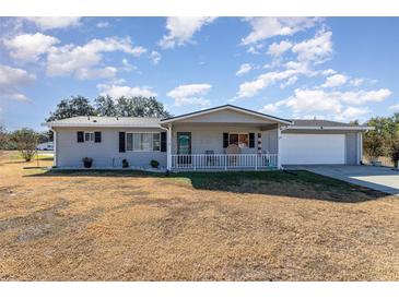 Ranch style home with carport and mature landscaping at 6524 Sw 108Th Pl, Ocala, FL 34476