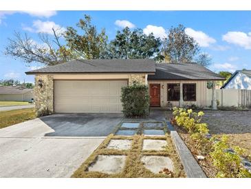 Charming one-story home with attached garage and landscaped yard at 986 Finrod Way, Casselberry, FL 32707