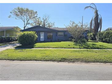 Ranch-style home with carport and mature landscaping at 4300 Colony Way, Orlando, FL 32808