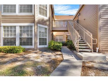 Exterior view of condo building showcasing stairs and landscaping at 696 Youngstown Pkwy # 307, Altamonte Springs, FL 32714