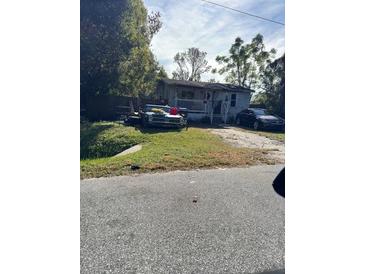Ranch-style home with carport and yard at 1530 Van Ness St, Orlando, FL 32810