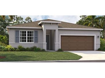 One-story home with gray exterior, brown garage door, and landscaped lawn at 3571 Dahlia Dr, Lake Hamilton, FL 33851