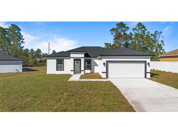 Newly constructed home with a modern exterior and attached garage at 4479 Sw 170Th Rd, Ocala, FL 34473
