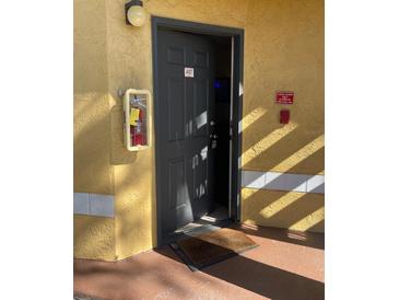 Exterior view of condo building, showing walkway and building facade at 5773 Gatlin Ave # 617, Orlando, FL 32822