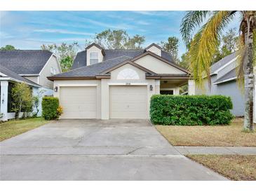 Two-story house with two-car garage and manicured landscaping at 2518 Woods Edge Cir, Orlando, FL 32817