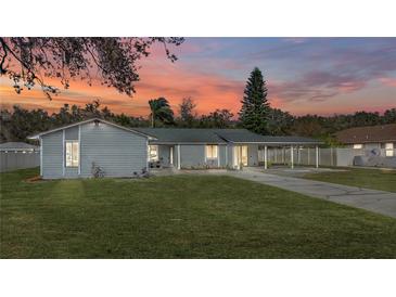 Newly renovated home with a spacious lawn and attached carport at 3743 Red Oak Ct, Lake Wales, FL 33898